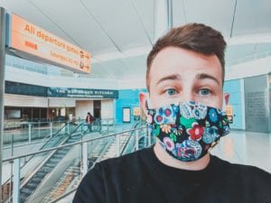 a man wearing a mask in an airport