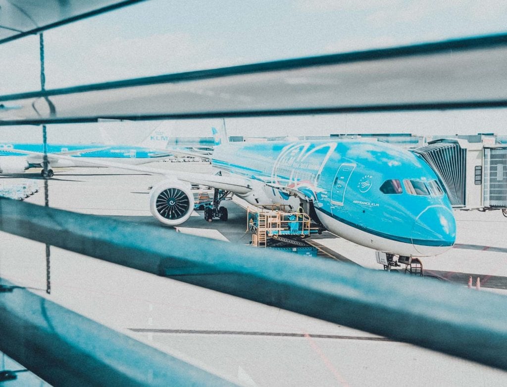a blue airplane parked at an airport