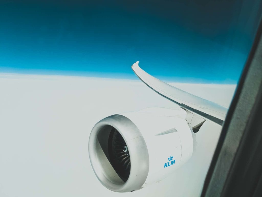 an airplane wing with a blue sky