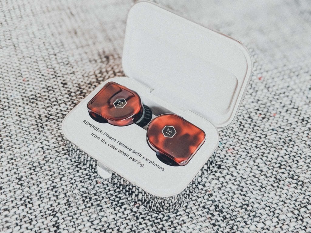 a box with two brown and black earbuds