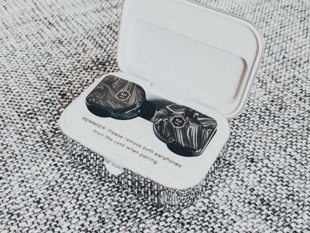 a black and white earbuds in a box