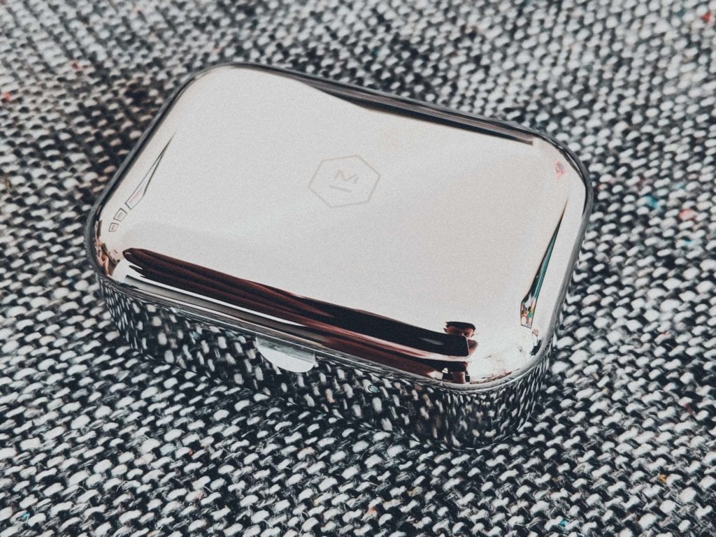 a silver metal box on a fabric surface