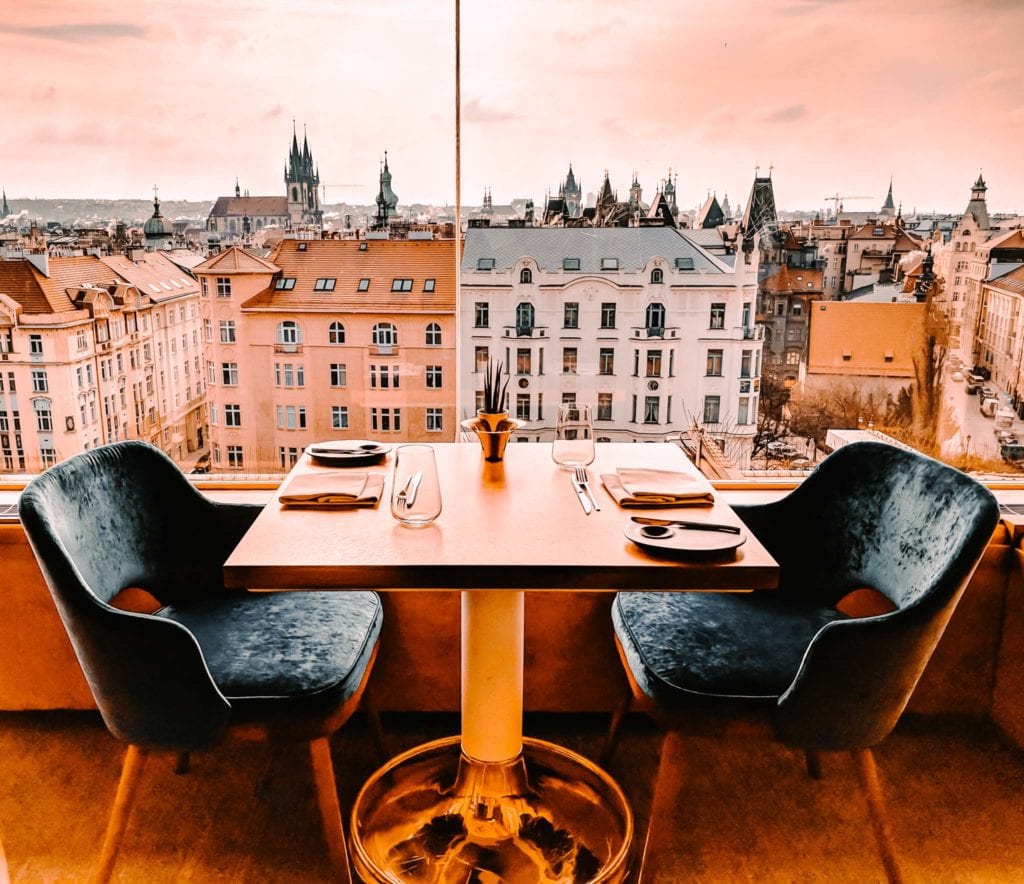 a table with chairs and a view of a city