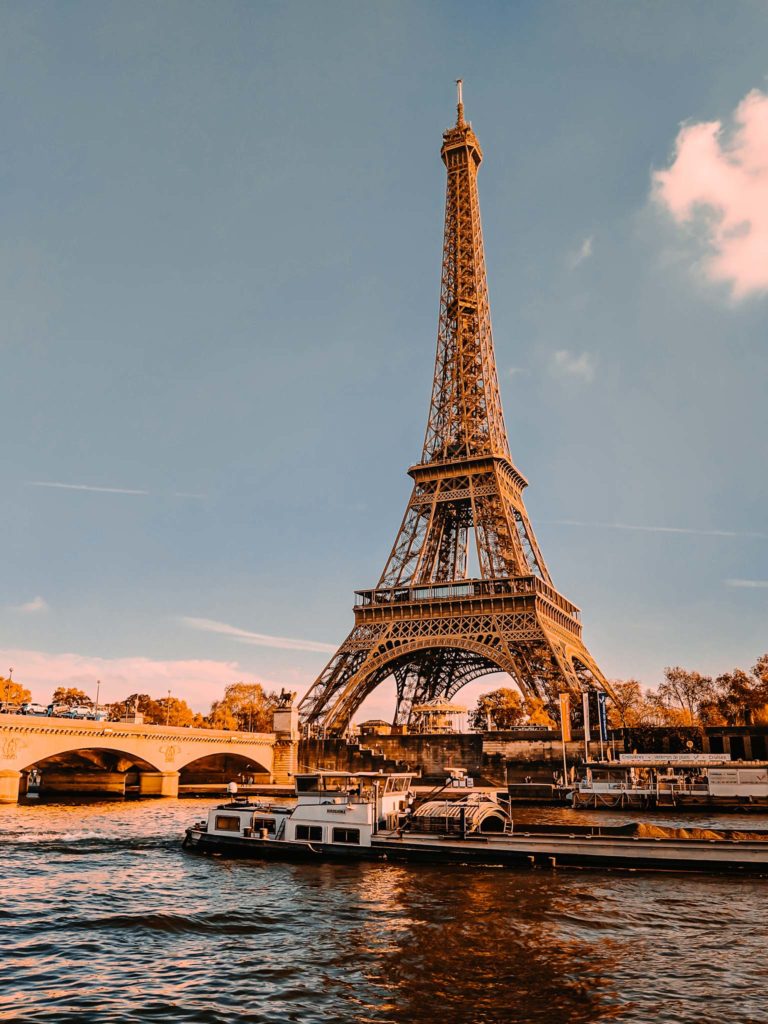 a boat on the water with Eiffel Tower in the background
