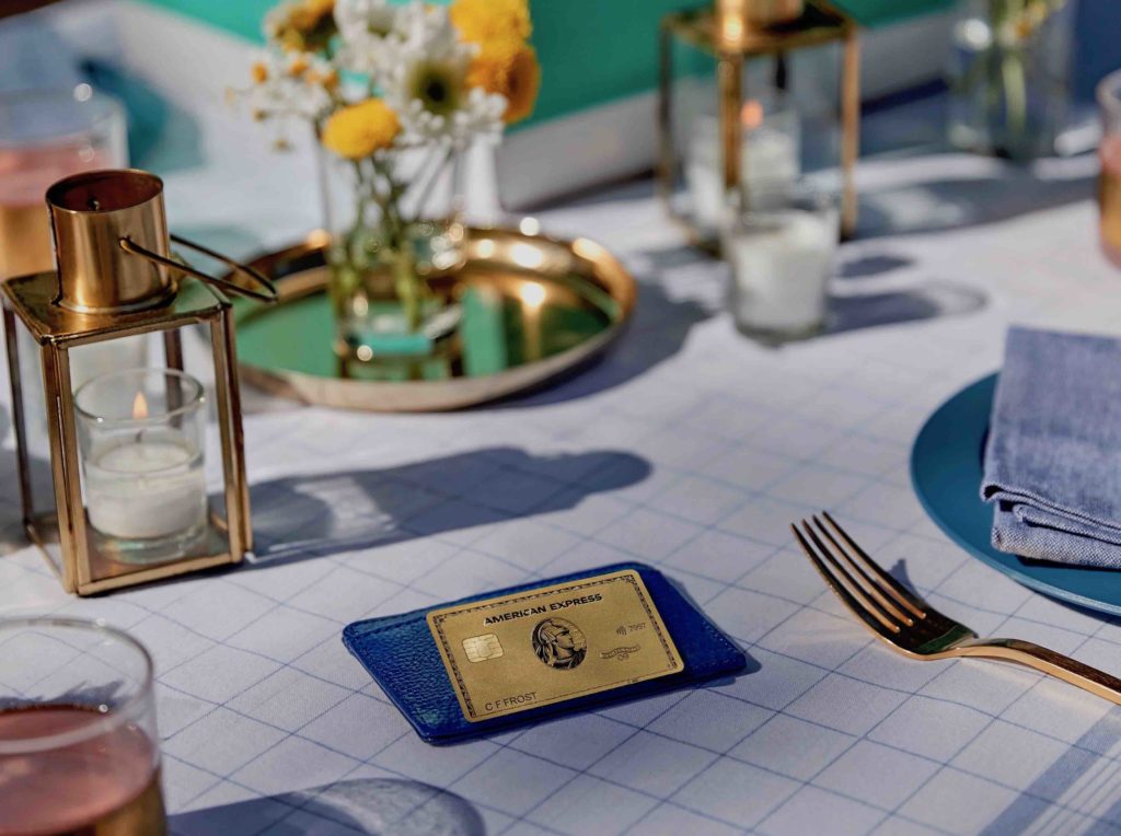 a table with a card and a fork and knife