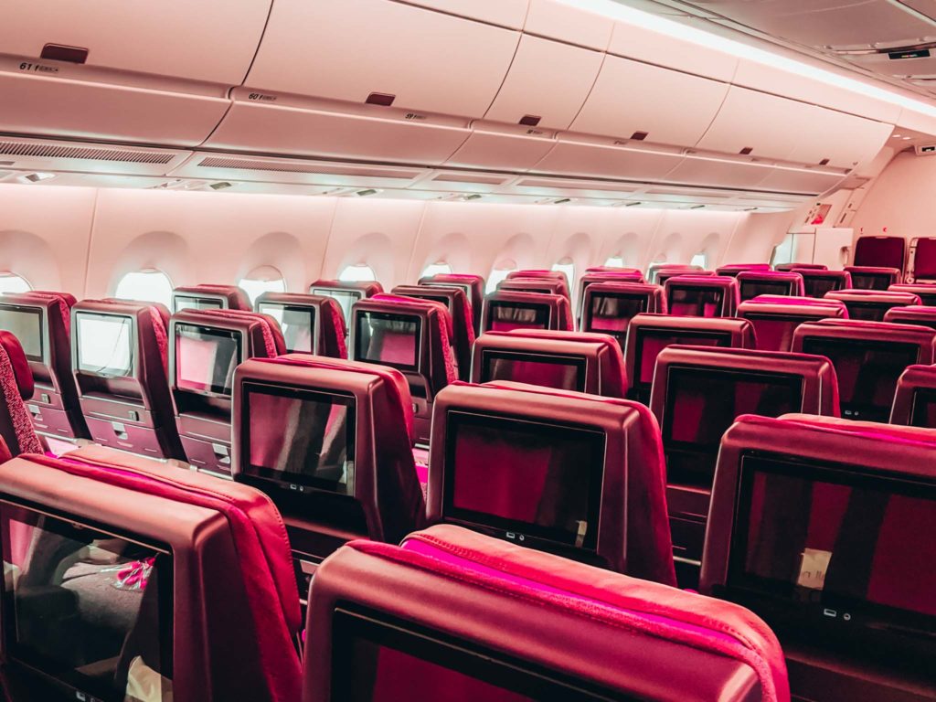 rows of red seats in an airplane