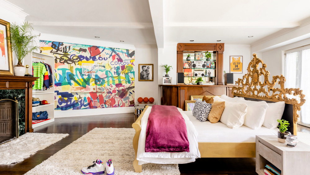 a bedroom with a large wall and a large painting on the wall