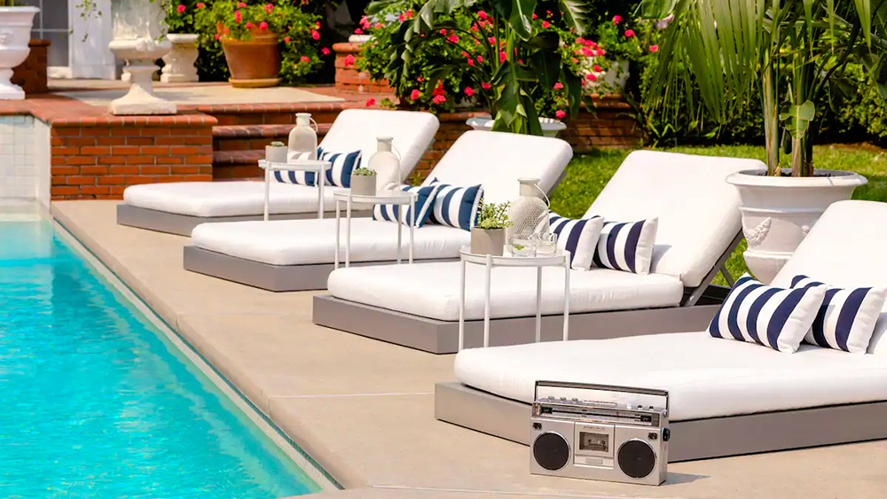 a pool with lounge chairs and a radio