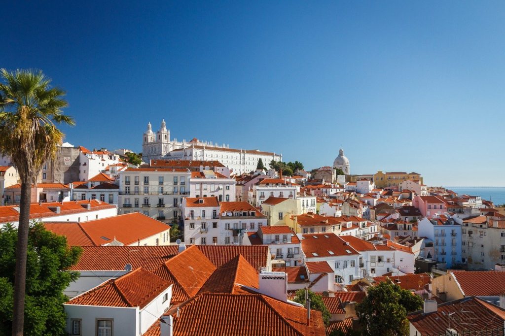 a group of white buildings with red roofs
