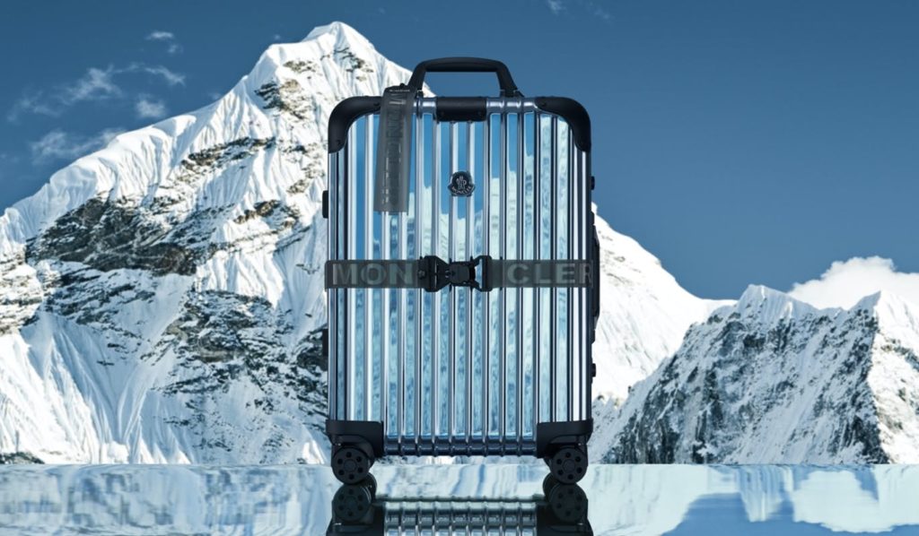 a luggage on a reflective surface with a mountain in the background