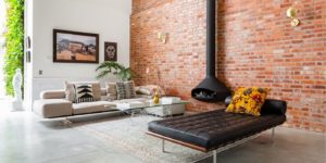 a living room with a brick wall and a couch