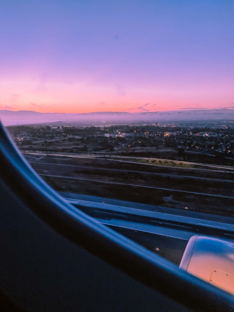 an airplane window overlooking a city