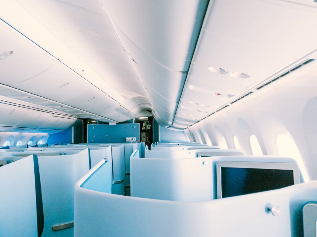 a white airplane with blue seats