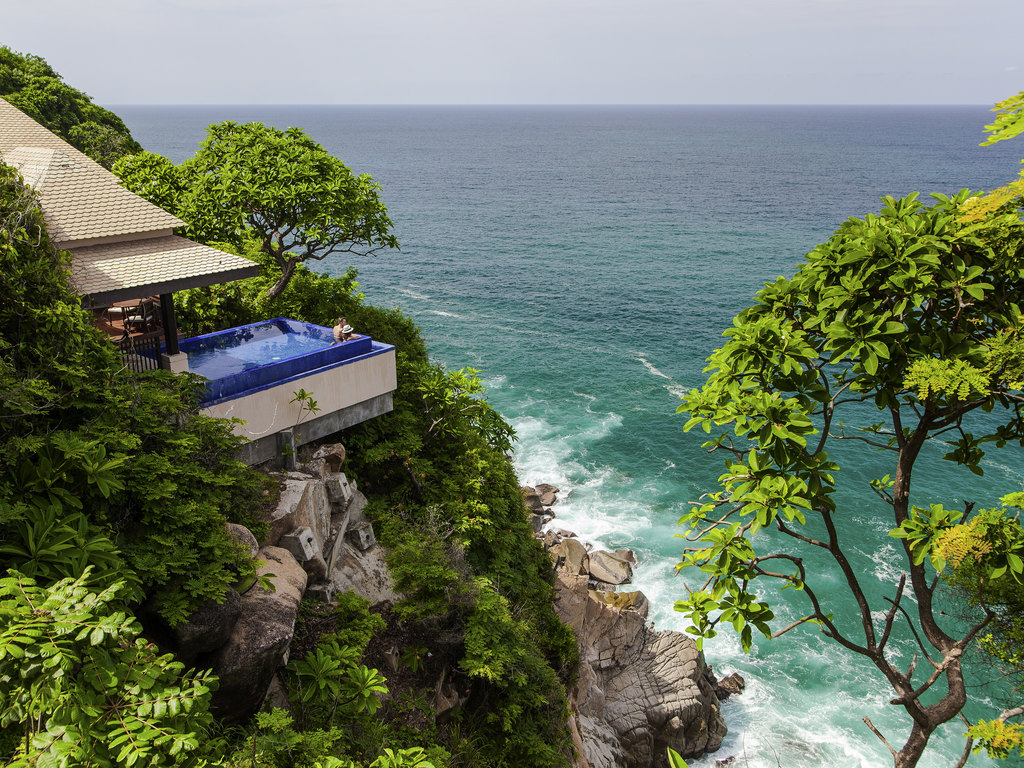 a building on a cliff overlooking the ocean