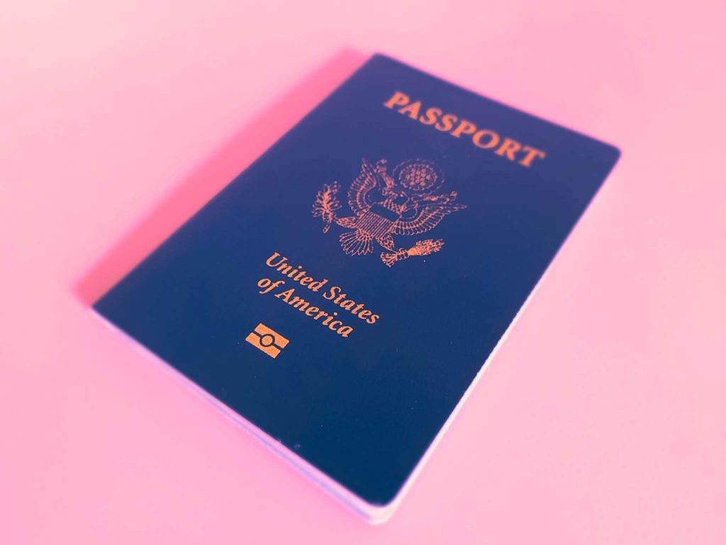 a blue passport with gold text on it