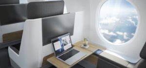 a laptop on a desk in a plane