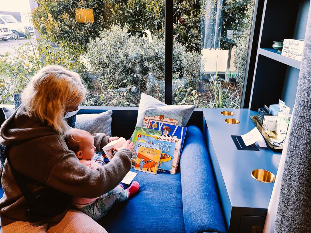 a woman reading a book to a baby