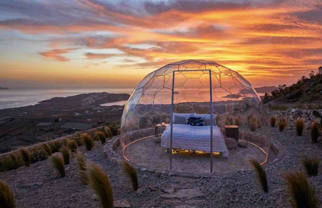a bed in a glass dome