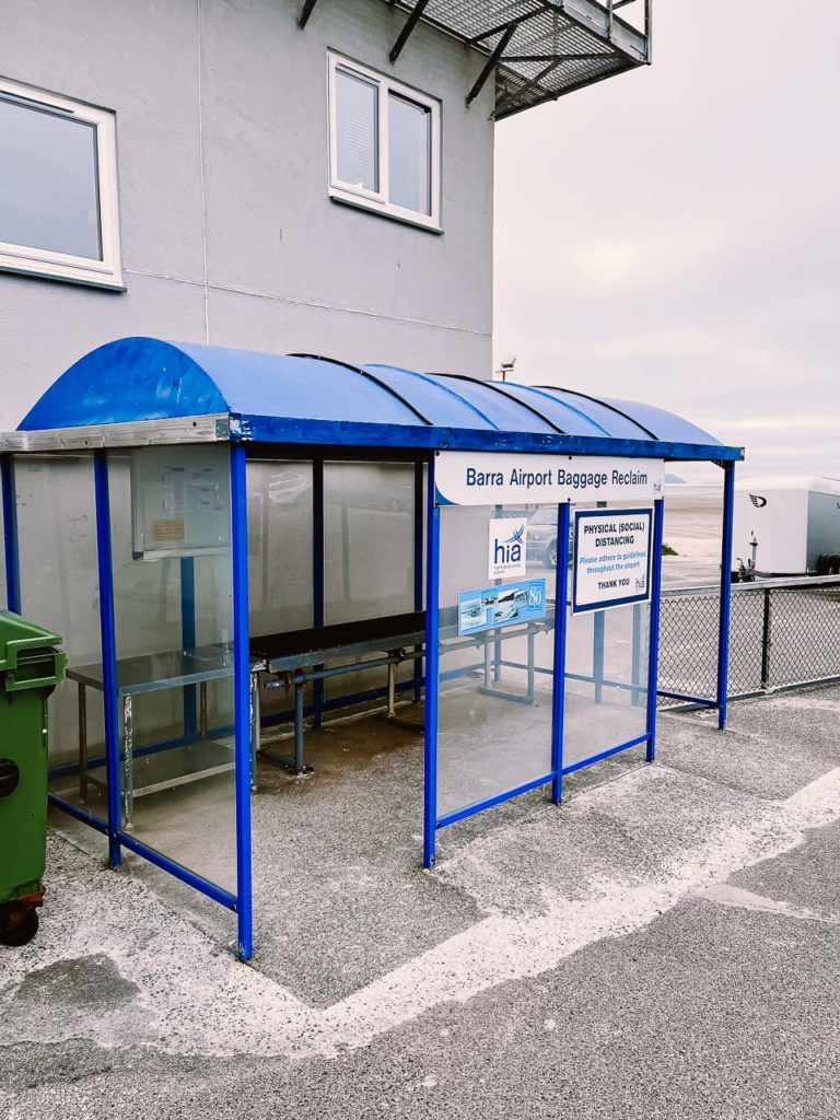 a blue bus stop with a blue roof