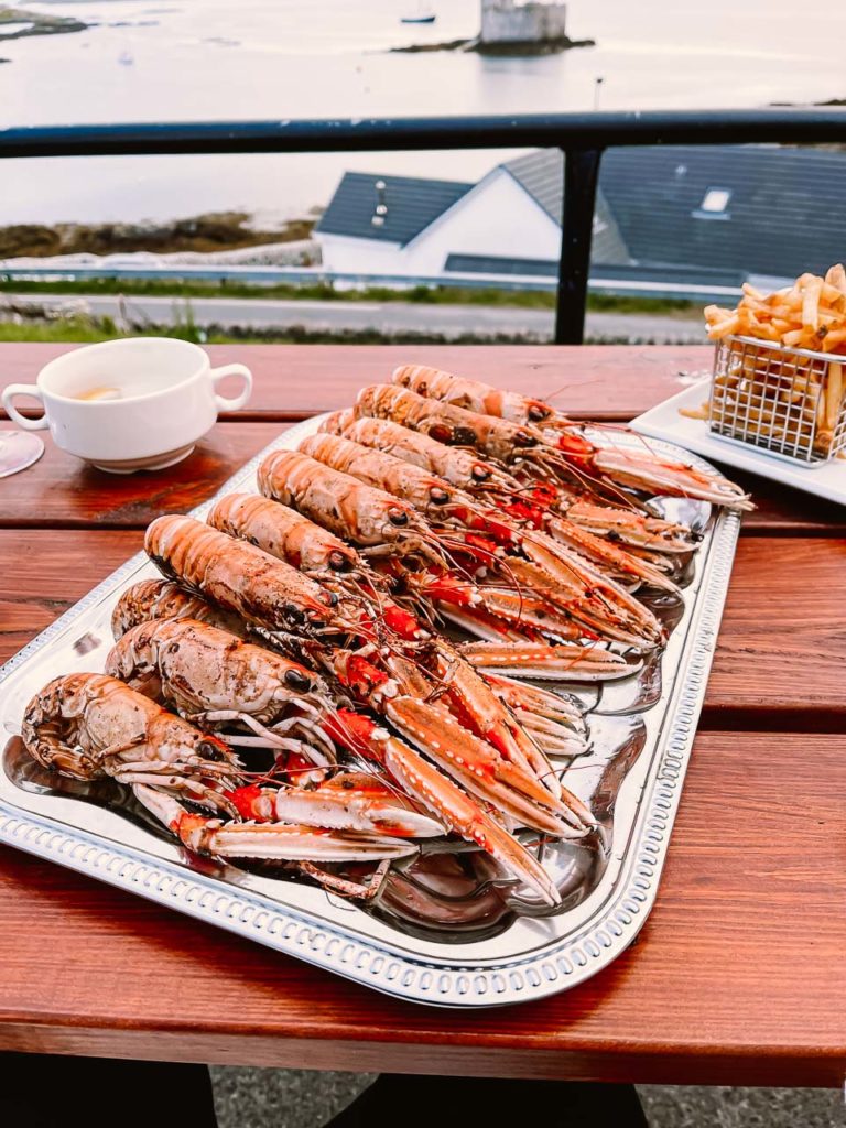 a plate of lobsters and fries on a table
