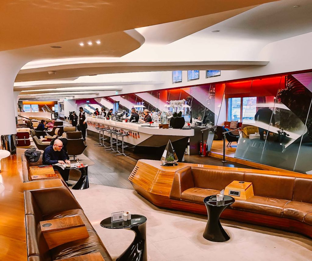 a room with tables and chairs and tables and people sitting at tables