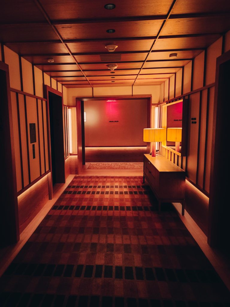 a hallway with a rug and a lamp