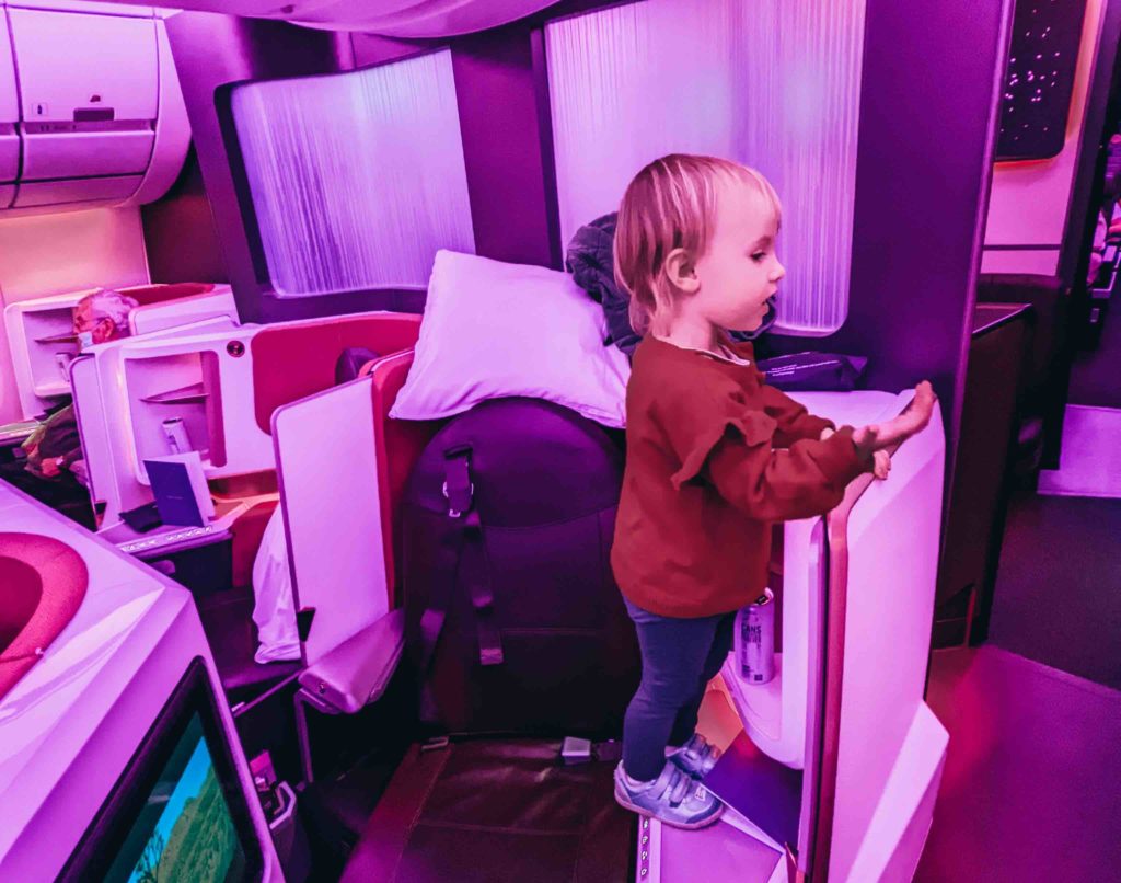 a child standing on a door in an airplane