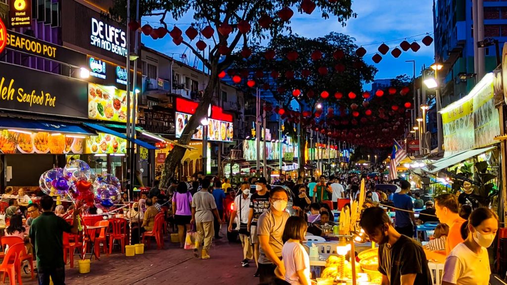 a street with people and lanterns
