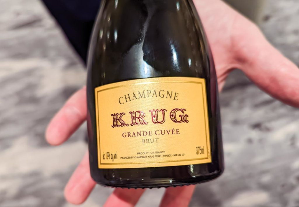 a hand holding a bottle of champagne