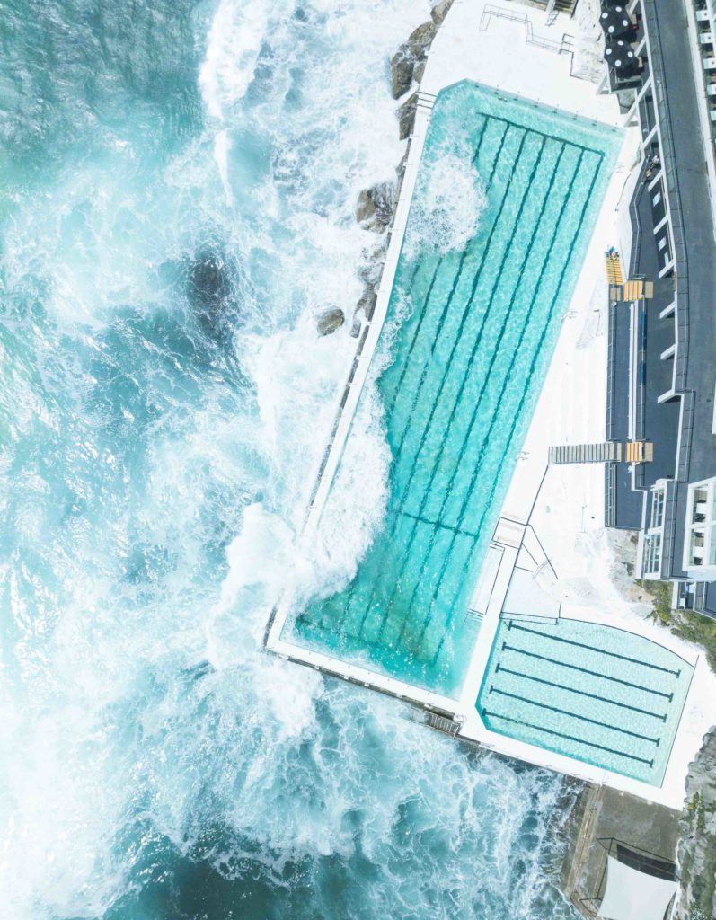 a swimming pool with waves crashing on it