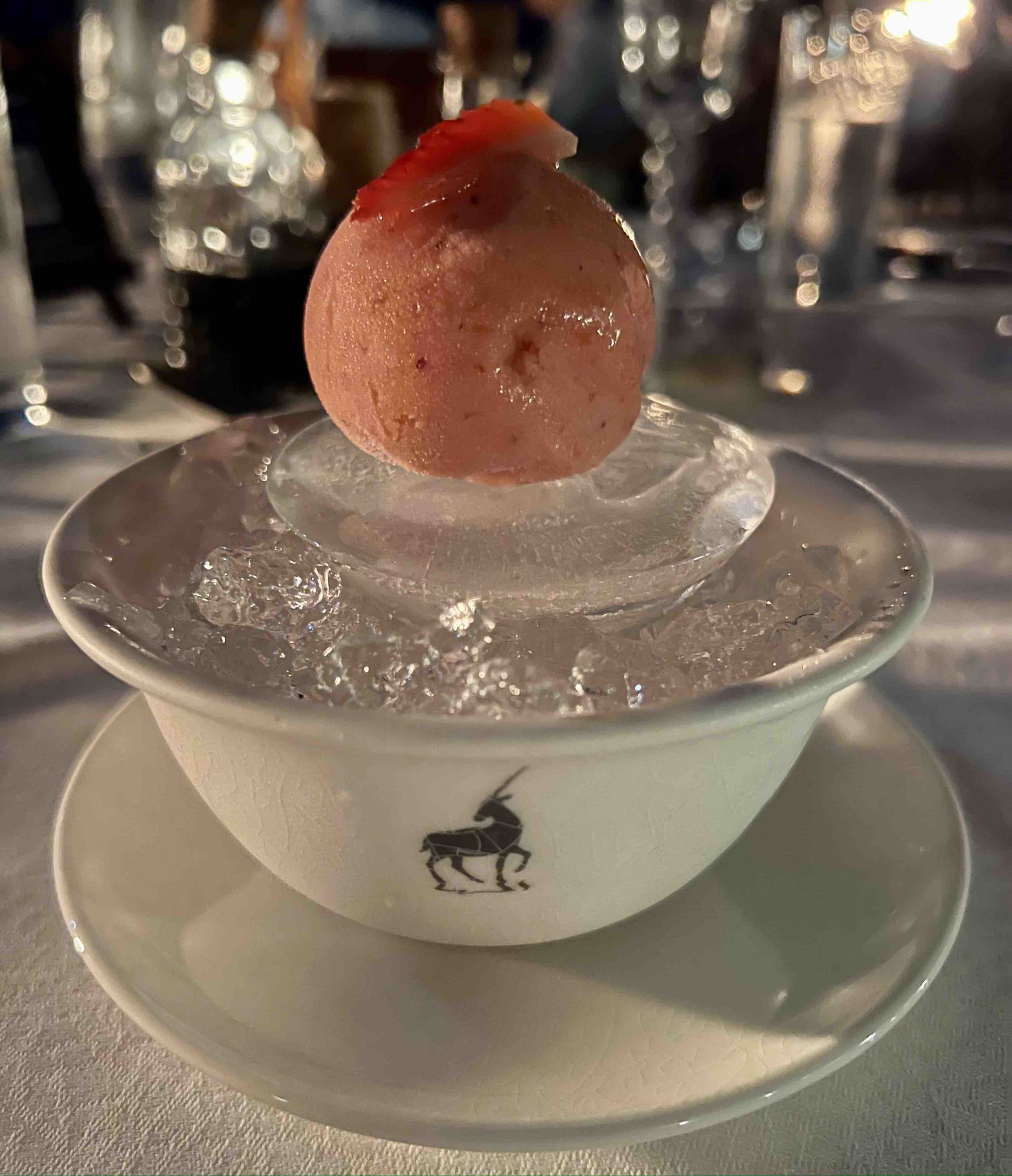 a bowl of ice cream with a round ball on top