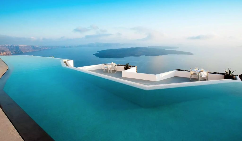 a pool with a view of the ocean and islands