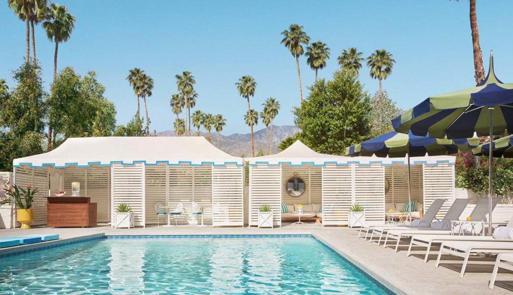 a pool with white awnings and chairs