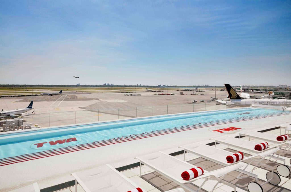 a pool and lounge chairs on a runway