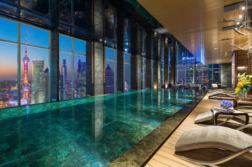 a pool in a building with a view of a city