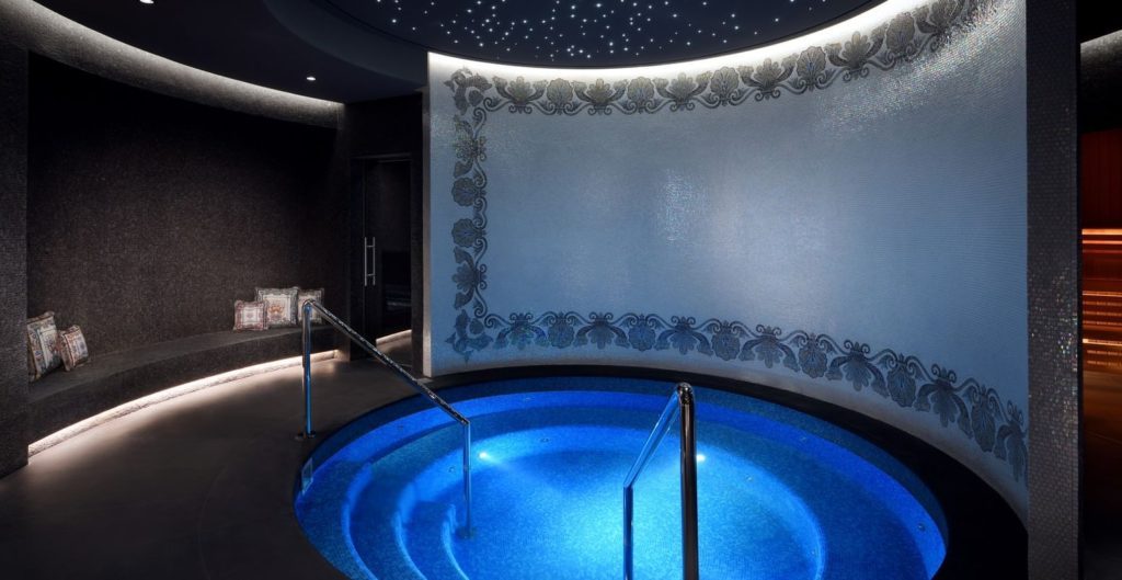 a pool with a blue water in a room