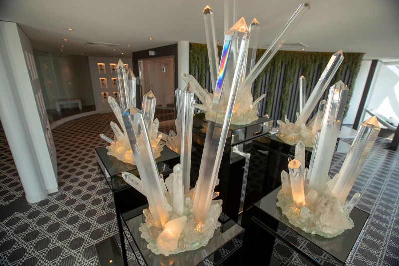 a group of crystal objects on black pedestals