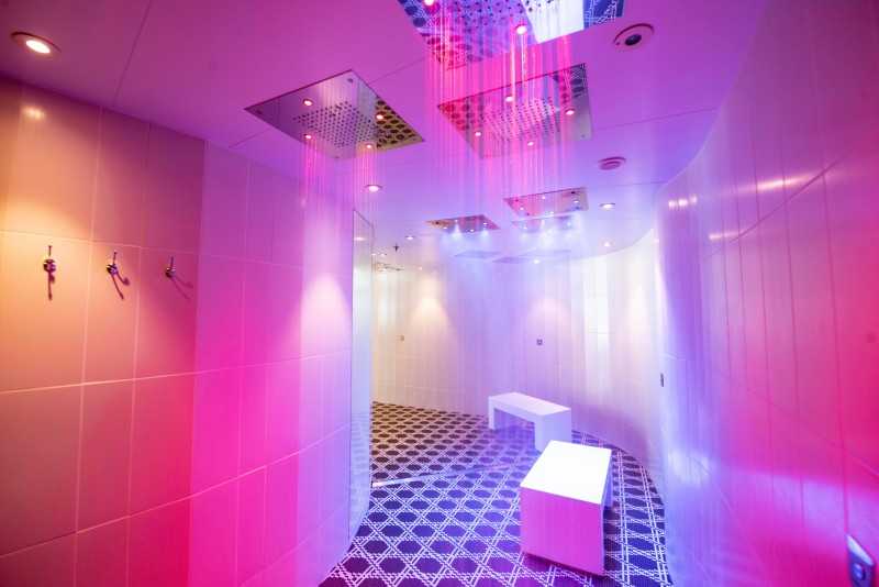 a shower room with pink lights
