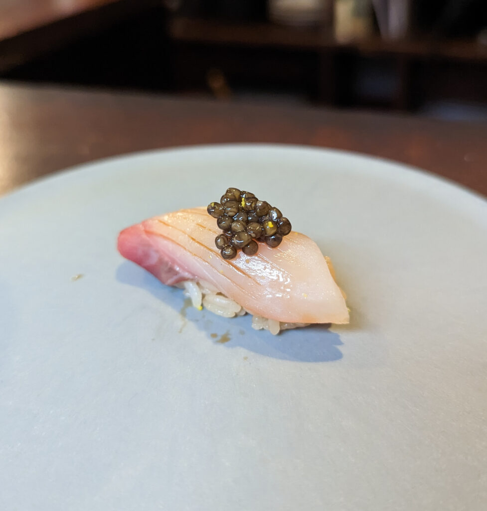 a sushi with black caviar on top