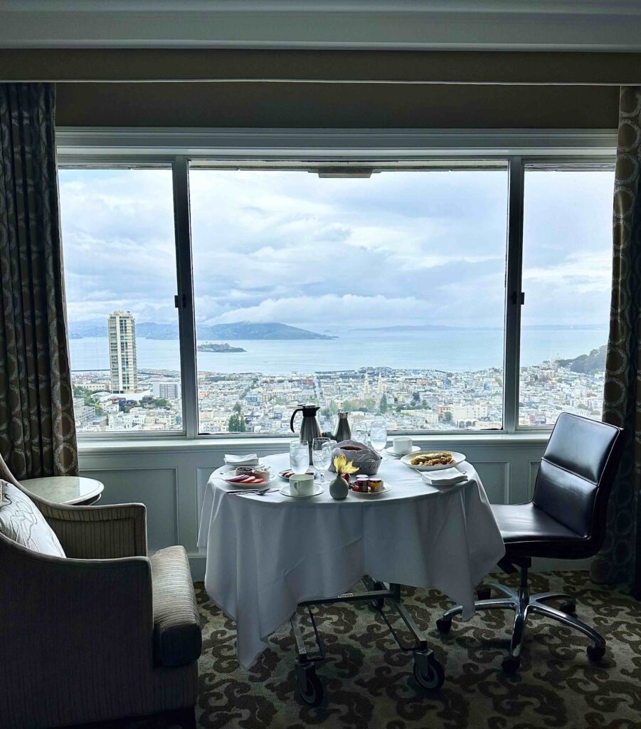 a table with food and a view of the city from the window