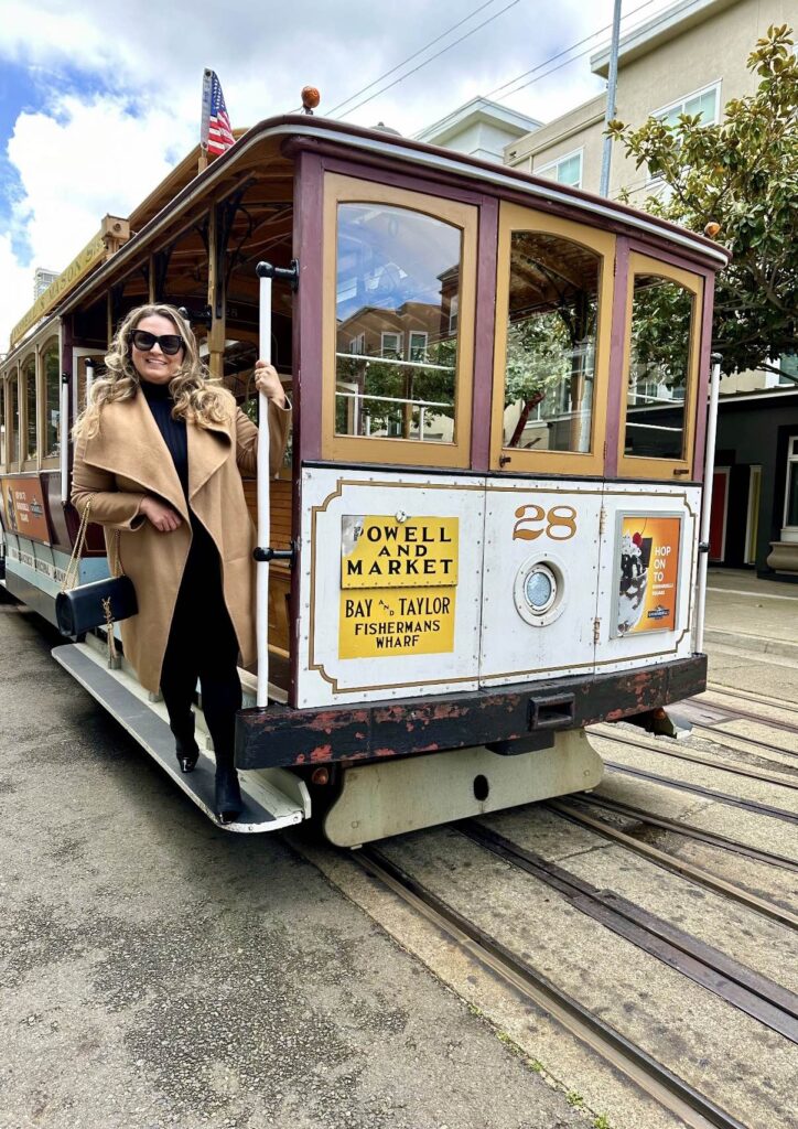 a woman standing on a trolley car